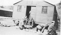 A group of Copperhead boys relaxing outside of their barracks which includes Everson, Braham, Martin and Condry.