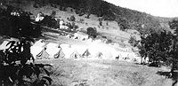 Early encampment: Tent City in 1935. In the background center is the Quiet Dell School. To its left and behind is the ribbon which is State Route 20 (Clarksburg to Buckhannon route) and is now in the vicinity of Exit 115 of I-79.