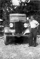 Mike Shaffer of Fairmont beside his ambulance at Camp Seebert. Mike was a jack of all trades in camp when he wasn't on call for medical emergencies.  After serving in WW ll, he woked in Marion County.